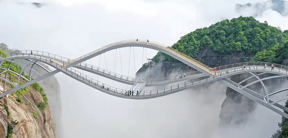 photo of a bridge against a foggy mountain background