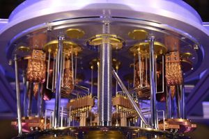 Close-up of a quantum computing system with gold and copper components arranged in a cylindrical structure.