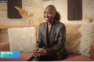 A young women smiles while sitting on a couch with beige cushions in a cozy, warmly lit room. A blue and green lower-third graphic identifies the person as Angel Foster from WWT.