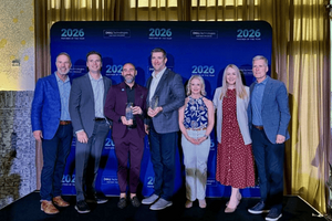 Seven WWT and Dell Technologies representatives pose in front of a 2026 Dell Technologies Partner of the Year step-and-repeat backdrop. Two individuals in the center hold glass award trophies.