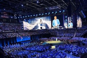 A view of the audience and stage at Cisco Live 2026 with Chuck Robbins presenting from the stage