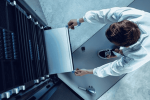 IT employee building a server rack with Dell PowerEdge Server and AMD GPU products