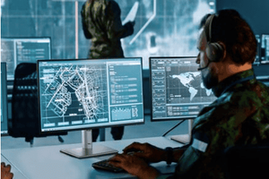 Male employee at desk looking at a map