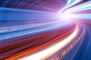 Colorful light trails and binary code streaming toward a bright focal point, symbolizing high-speed data and digital connectivity.