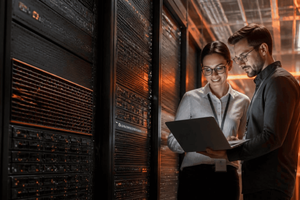 Everpure Accelerate Recap Image Two Technical Professionals in Data Center looking at computer screen 