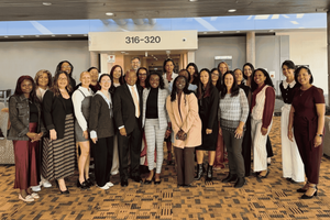 A large group of WWT and Hope Ignites representatives posing together in a conference center lobby.