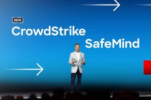 Presenter on stage in front of a blue screen displaying CrowdStrike SafeMind branding and directional arrows during a product announcement event.
