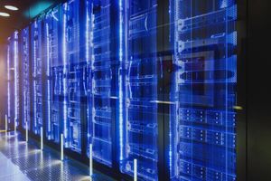 Server racks with blue LED lighting in a modern data center, highlighting rows of high-performance computing and storage infrastructure.