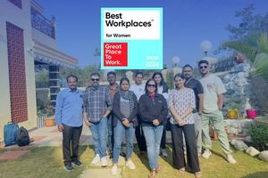 Team members gather outdoors beneath a Best Workplaces for Women India 2026 recognition graphic from Great Place to Work.