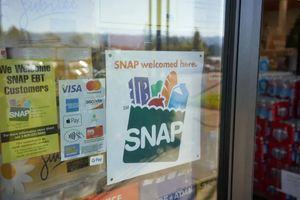 Store entrance window displaying signs indicating SNAP/EBT benefits are accepted, alongside payment method logos and a prominent SNAP welcome poster.  Provide your feedback on BizChat