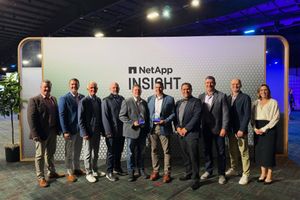Generating response Copilot said:  NetApp Insight attendees pose for a group photo in front of a NetApp Insight display, with two individuals holding award trophies at the center of the stage.