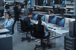 Federal employees in the office at their desks on computers using the GB3000 