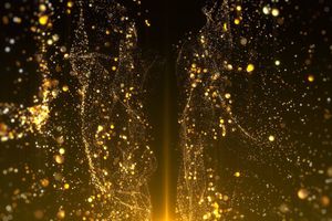 Abstract golden particles form flowing, wave-like shapes against a dark background, illuminated by a warm glow from below.