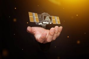 Hand holding a digital model labeled "Orbital Data Center" against a glowing background.