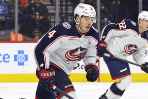 Columbus Blue Jackets players in action during a hockey game.